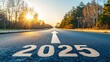 © Suphawan - Empty road with  and a forward-pointing arrow under a clear, hopeful sky, setting the tone for a positive new year journey