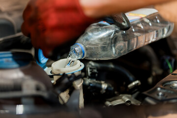 Refilling Engine Coolant in a Car with a Water Bottle