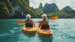© Nicat - A retired couple paddling a kayak at Angthong Marine Park in Thailand, symbolizing active elderly lifestyles.