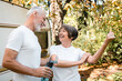 © InsideCreativeHouse - Strong happy old elderly senior couple athletes doing sport training together while in eco-tour
