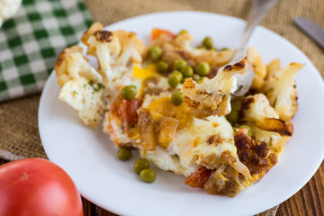 Sticker - fried omelette with cauliflower and vegetables in a plate