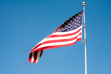 American flag against blue sky drifting with the wind in Florida