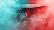 ©  Jovaduplex - A bearded man with a hat is partially obscured by swirling red and blue smoke, creating a contrast that adds to his mysterious and intriguing appearance.