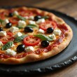 © Tasha - Delicious Mediterranean Pizza with Fresh Toppings on Rustic Black Plate