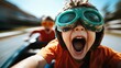 ©  Jovaduplex - Two children in orange shirts and goggles experience an exhilarating ride, their faces displaying sheer excitement, embodying joy and adventurous spirit.