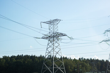 A tall telephone pole standing against a vast blue sky backdrop