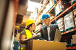 © Davor - Warehouse worker discussing logistics with manager over a laptop