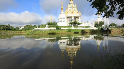 Wall Mural - video background of the morning sun light overlooking the old pagoda in the middle of the water(Wat Thung Setthi) in Khon Kaen of Thailand, is beautiful and the blur of the wind blows.