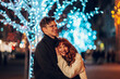 © Zamrznuti tonovi - Loving festive couple hugging on street on christmas and new year's eve