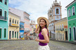 © zigres - Tourism in Salvador de Bahia, Brazil. Traveler girl visiting the Pelourinho historic center of Salvador de Bahia the first capital of Brazil, UNESCO World Heritage.
