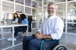 © zinkevych - Confident businessman in wheelchair sitting in his modern office