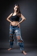 © Mountains Hunter - A beautiful brunette poses in the studio wearing a top and jeans.