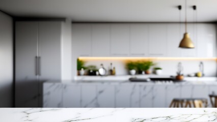 A blurred image of a modern kitchen with white cabinets, a marble countertop, and a gold pendant light.  A white marble surface in the foreground provides a blank space for product placement.