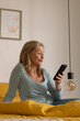 © Wavebreak Media - Smiling senior woman video chatting on smartphone at home, enjoying conversation