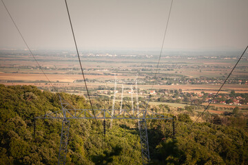 High voltage power lines stretching across the landscape. The image highlights the infrastructure involved in electricity supply and energy distribution in Serbia. It reflects the technological aspect