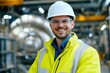 © Vooglo.com - A male engineer in a white hard hat and yellow jacket stands confidently in a high-tech industrial