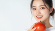 © niwat - Portrait of beauty health Asian woman having fun hold tomato cooking, vegan food healthy eat, fresh vegetable, Lycopene, vitamins, skincare, vegetarian in kitchen.Diet.Fitness, healthy food