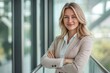 © Vooglo.com - Smiling confident businesswoman with arms crossed standing on balcony. Depth of field