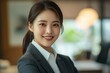 © Vooglo.com - Smiling elegant confident young professional Korean business woman