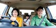 © Reubens Stock Photos - Asian Parents and Child Smiling on Road Trip in Family Vehicle