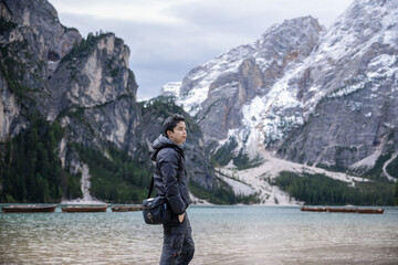 Man enjoy view of lake Braies or Lago di Braies in Dolomites, Italy.