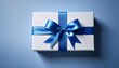 © Behram - White gift box with a blue ribbon, creating a simple and elegant design, perfect for gift-giving or holiday themes