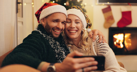 Sticker - Christmas, happy and selfie of couple in home take photo for profile picture, social media post and memory. Love, bonding and man and woman hug on sofa for festive tradition, holiday and vacation