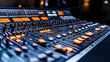 © altitudevisual - Close-up of an audio mixing console with illuminated buttons and sliders in a recording studio setting