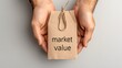© Paisan - Hands holding a product tag illustrating market value in a minimalistic and modern presentation. Value and Price Concept