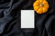 © Pascal - Flatlay of Halloween blank white paper greeting card menu invitation rsvp POD mock up pumpkin fabric black backdrop for country rural boho Autumn background empty cardstock note invite above view