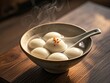 © scarlett - closeup of big tangyuan yuanxiao (glutinous rice dumpling balls) with hot smoke   for lunar new year festival food.