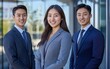 © Who is Santi - A smiling trio of young asian business professionals stands in front of a contemporary office building, radiating confidence.