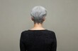 © SY - Woman with short gray hair, back view. The photo shows a woman with her back turned, ideal for showcasing clothing or hair styles, especially for mature women.