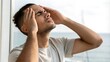 © Vera - Man suffering from headache and holding his head indoors
