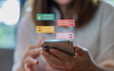 Human hand using smartphone typing Live chat chatting and social network concepts, chatting conversation working at home in chat box icons pop up. Social media marketing technology concept