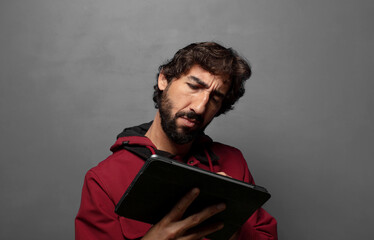 Poster - young adult man using a touch screen tablet