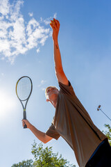 low shot professional tennis court young curly guy technically performs the first serve in the game examines it clay court markings