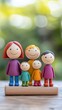 © Major - Colorful Wooden Family Figurines on a Natural Background