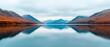 © maesarin - Serene alpine lake surrounded by majestic mountains the calm waters perfectly reflecting the scenic vista in a peaceful and tranquil natural landscape
