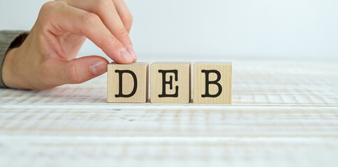 Deb text on wooden cubes on wooden background