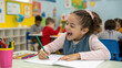 © Albaloshi - little child drawing The future artist at work amidst a colorful classroom environment. Early education and the joy of learning captured in one moment.
