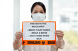 © peopleimages.com - Portrait, woman and poster for covid19 protection with list, prevention measures or virus information of safety. Girl, billboard and face mask of medical warning, health compliance and emergency news