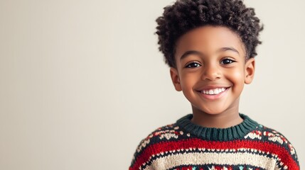 A joyful young boy beams, wearing a festive holiday sweater. Pure holiday cheer captured in this heartwarming portrait!