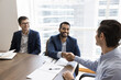 © fizkes - Happy young Indian project owner man shaking hands with investor on corporate meeting after negotiation, getting successful agreement, investment. Businessman giving handshake to consultant, broker