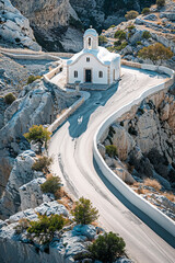 Wall Mural - Small white chapel on a winding mountain road, surrounded by rocky landscape and trees