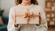 © TiMeto - Excited Young Woman Holding Unexpected Gift with Joyful Expression in Cozy Indoor Setting