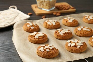 Tasty cookies with almond flakes on wooden table, closeup