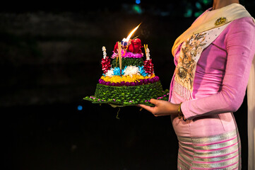 Woman holding handmade Kratong made by banana leaves for celebrate Loi Kratong festival most popular event in Chiangmai, Thailand