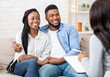 © Prostock-studio - Happy black couple sitting in counselor's office after successful marital therapy, copy space