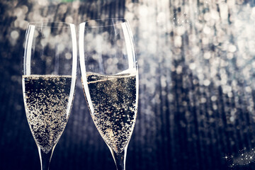 Wall Mural - toasting with champagne glasses on sparkling holiday background - Fireworks at New Year and copy space